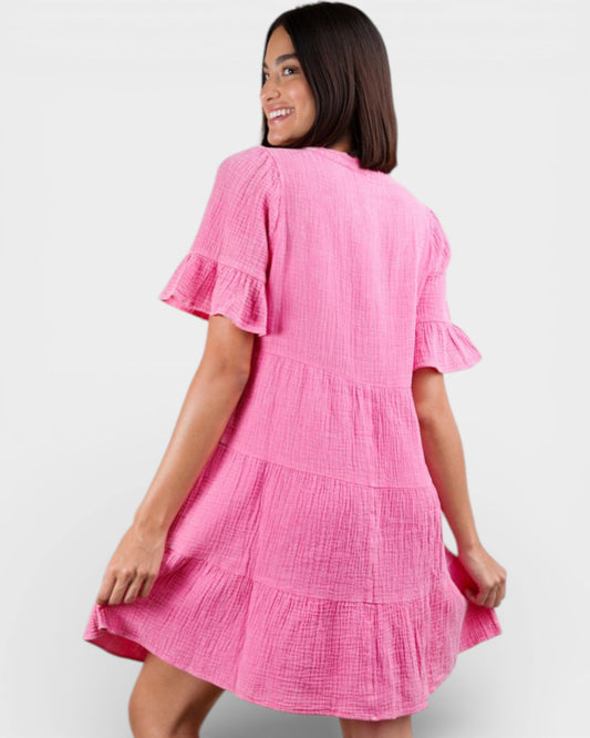 Woman wearing a pink dress against a white background