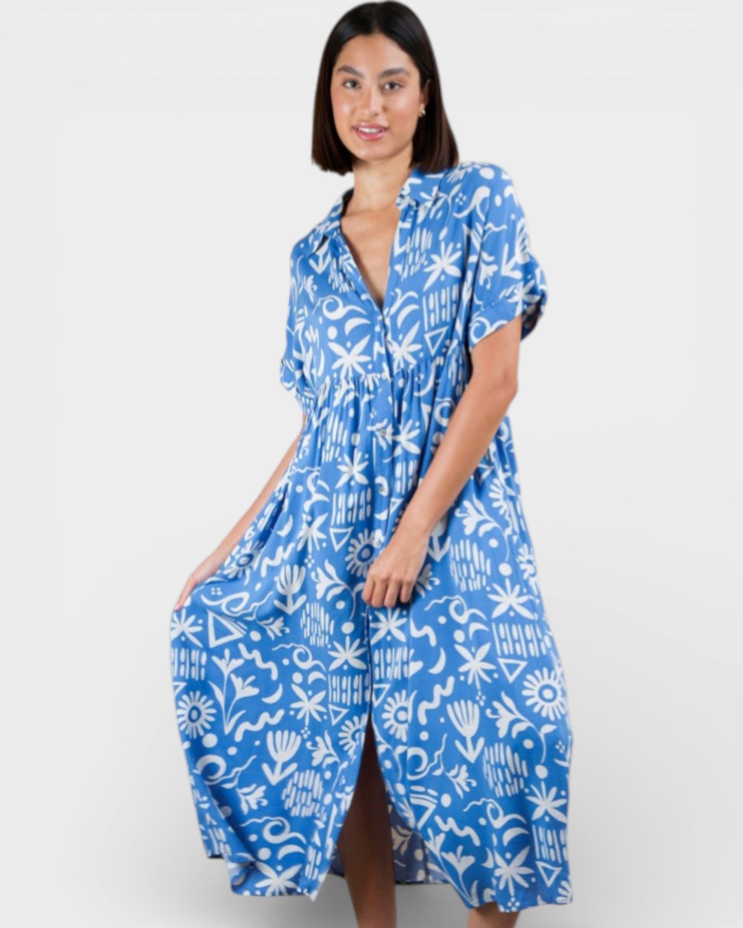 Woman wearing a blue and white patterned dress on a white background