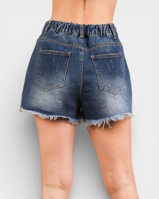 Blue denim shorts on a plain background