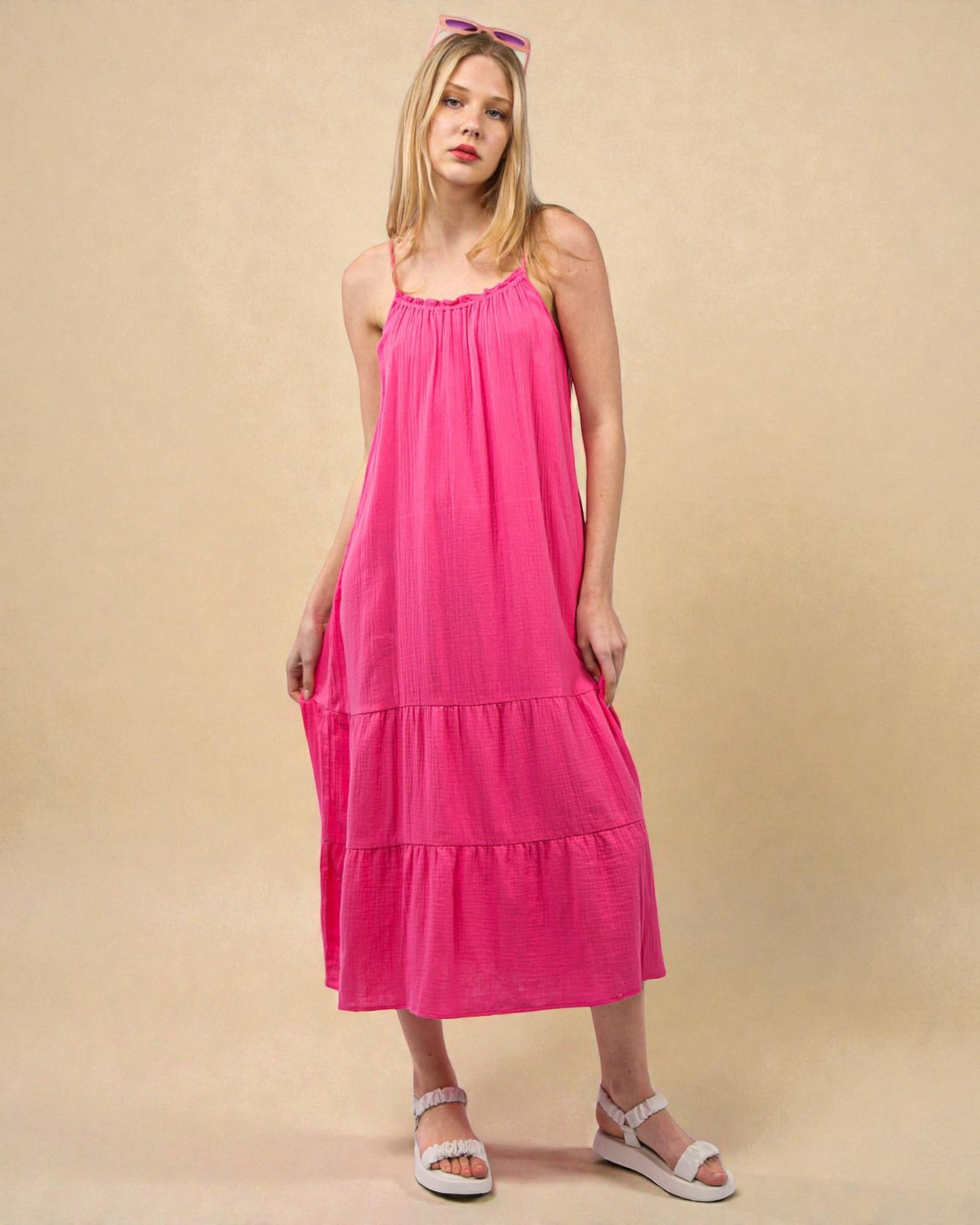 Woman wearing a pink dress against a beige background