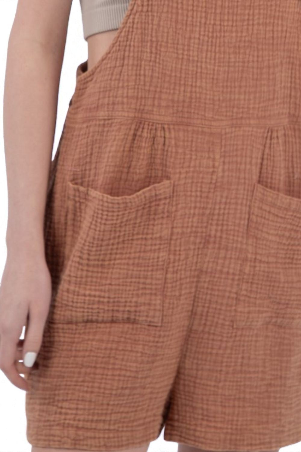 Brown checkered shorts with pockets on a plain background