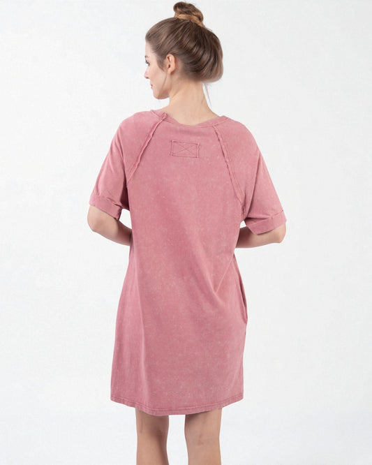 Woman wearing a pink dress on a white background