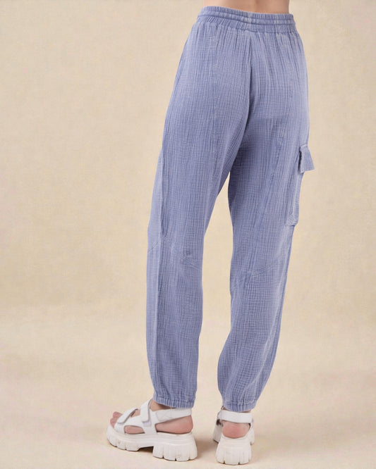 Blue checkered pants worn by a person on a beige background