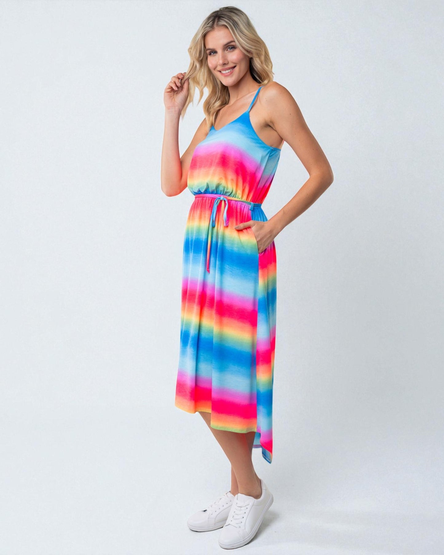 Woman wearing a colorful tie-dye dress on a white background