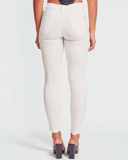 White pants worn by a person on a white background