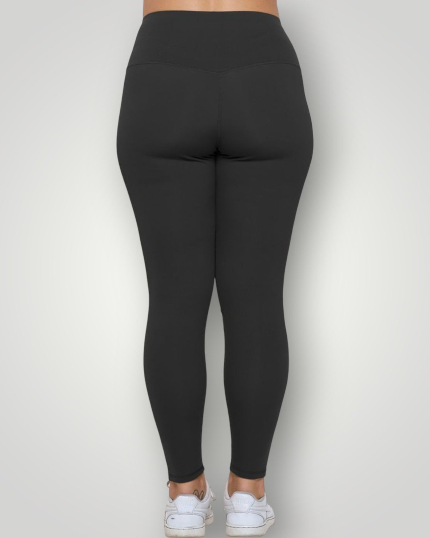 Black leggings worn by a person on a white background