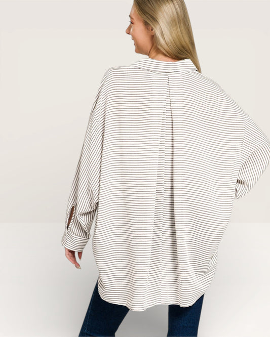 Woman wearing a striped shirt with a white background