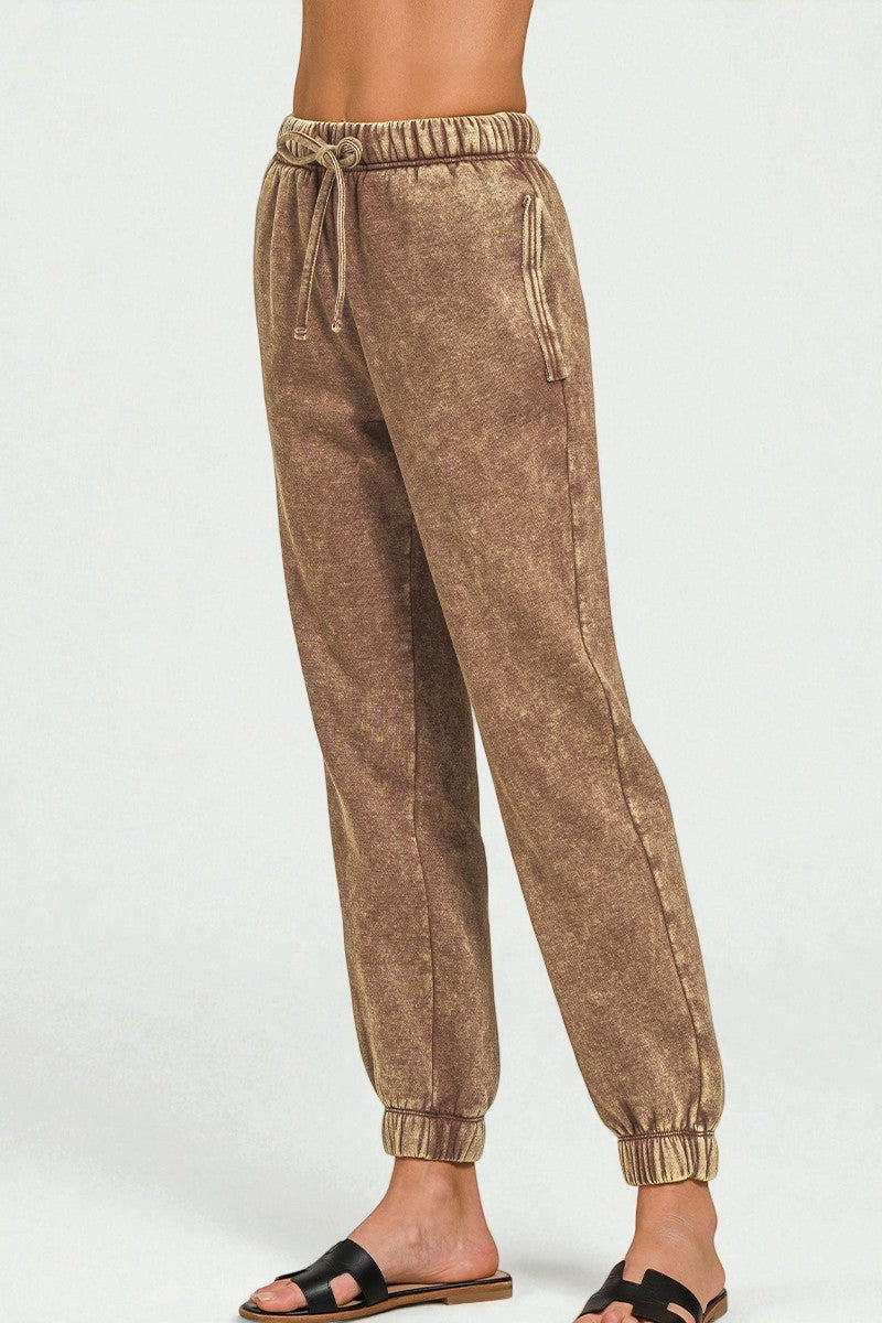 Brown jogger pants on a white background