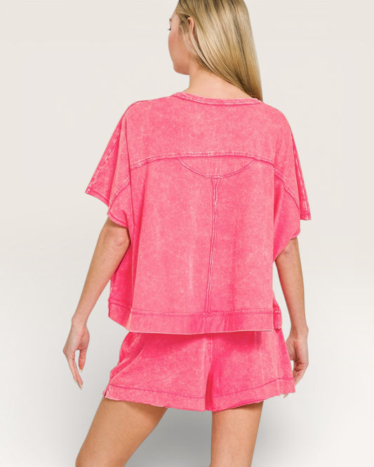 Woman wearing a pink denim outfit on a plain background