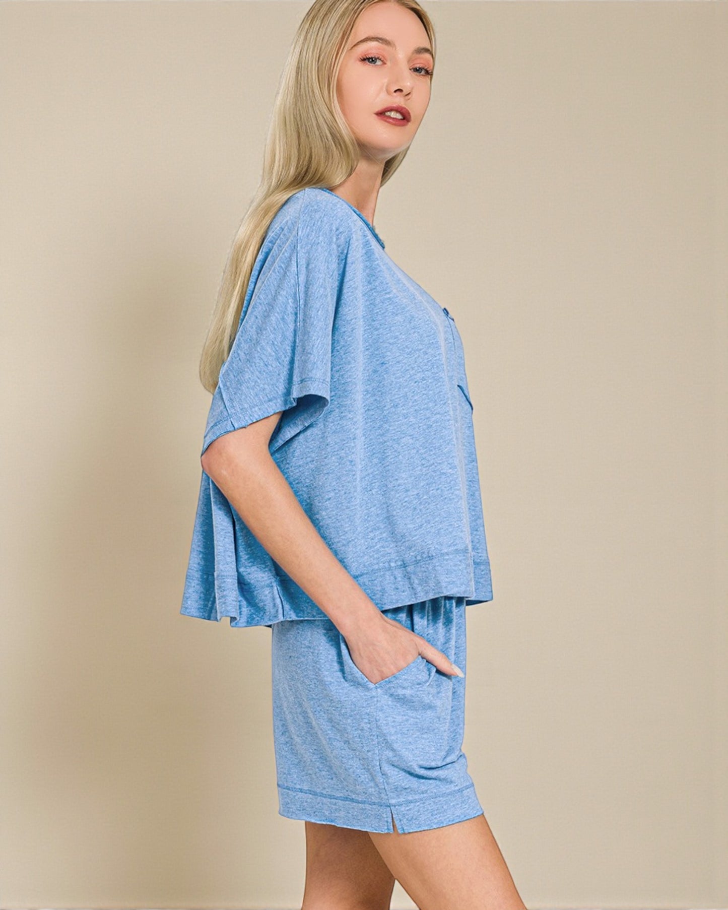 Woman wearing a blue outfit with a plain background