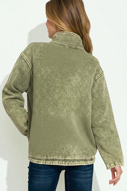 Person wearing a green fleece jacket on a white background