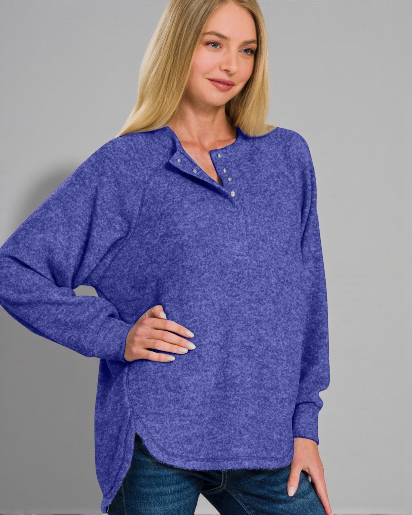 Woman wearing a blue sweater against a gray background