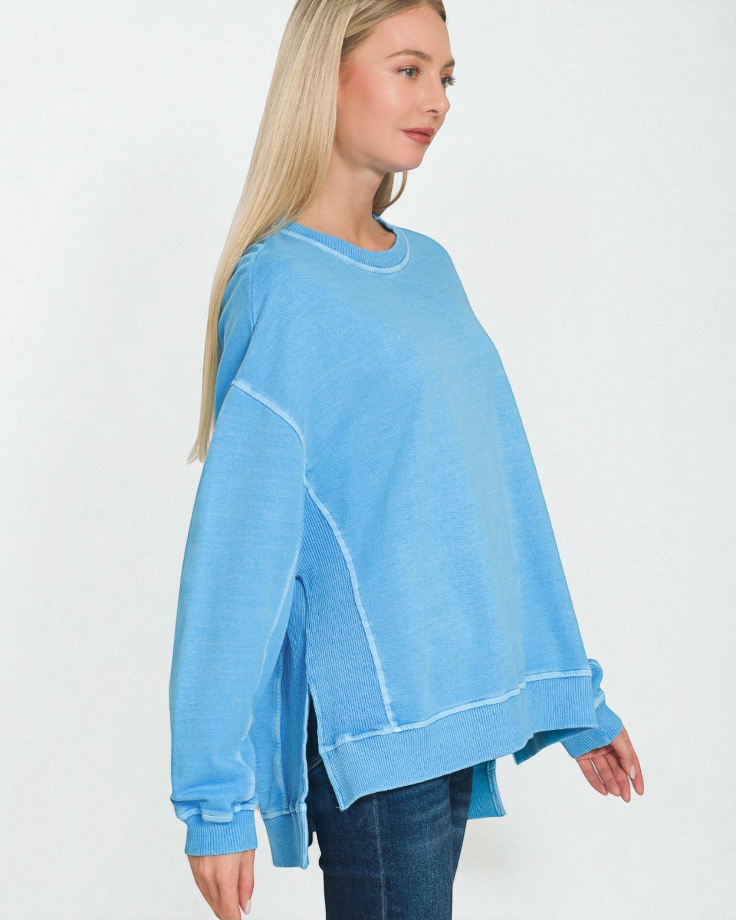 Woman wearing a light blue sweatshirt on a white background