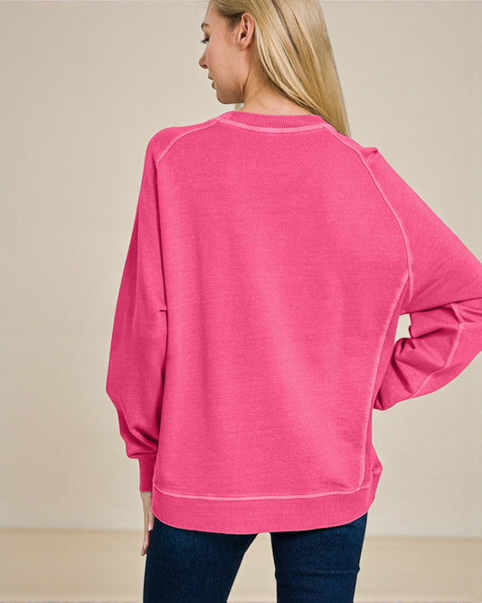 Person wearing a pink sweatshirt on a beige background