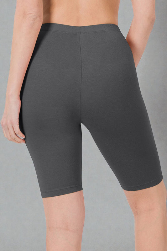 Dark gray bike shorts worn by a person on a gray background
