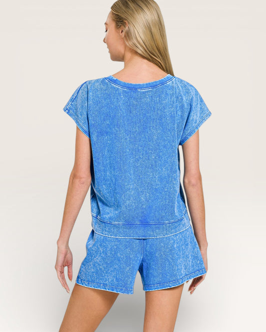 Woman wearing a blue denim outfit on a plain background