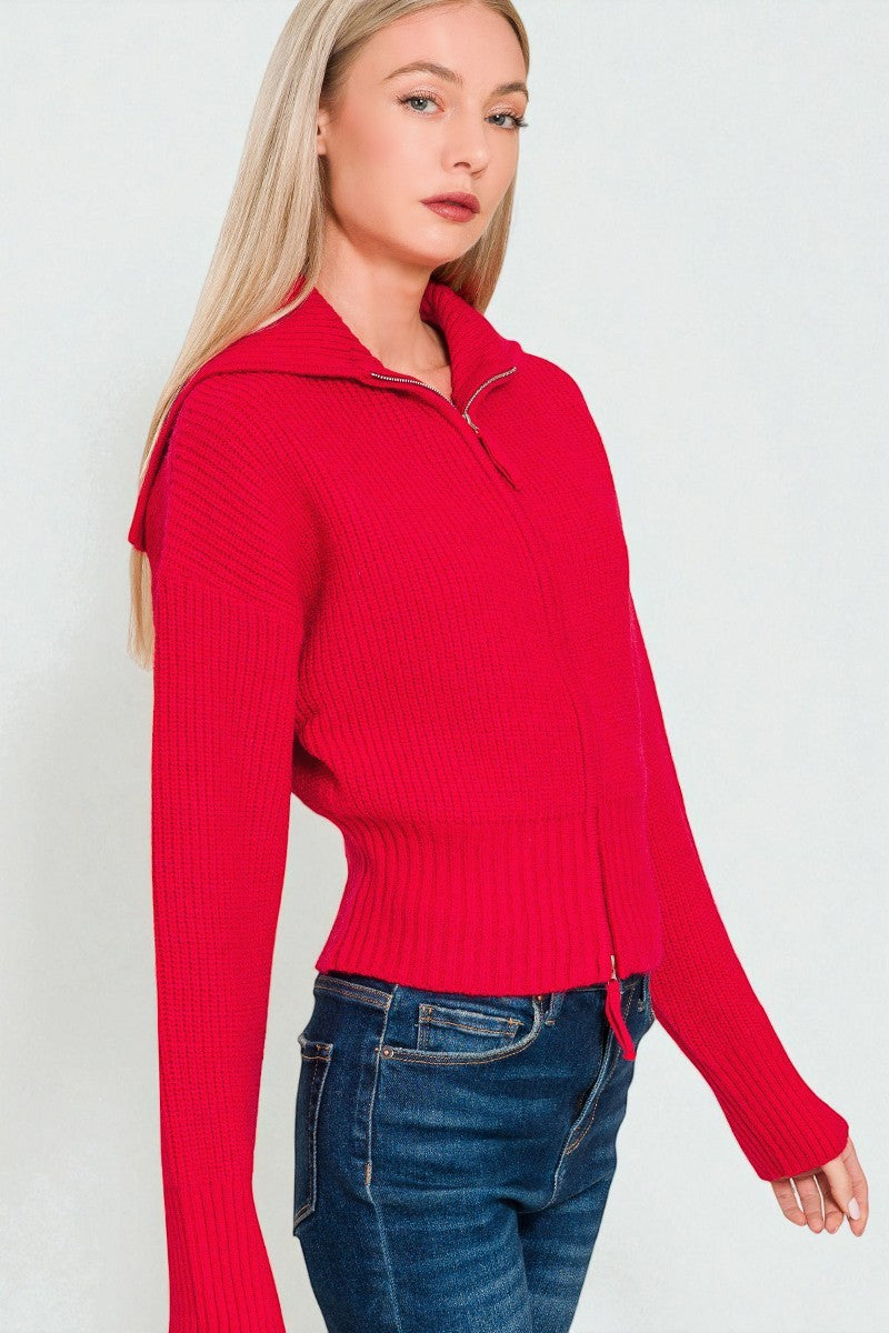 Woman wearing a red sweater with a white background