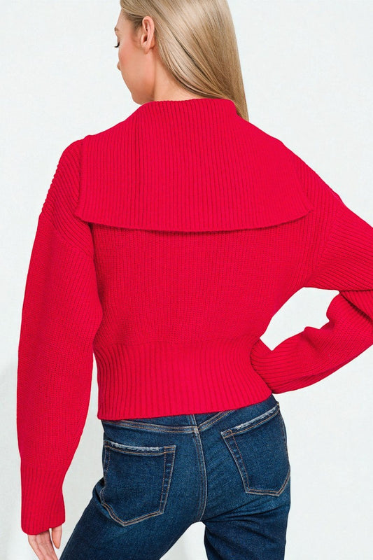 Person wearing a red sweater and blue jeans on a white background