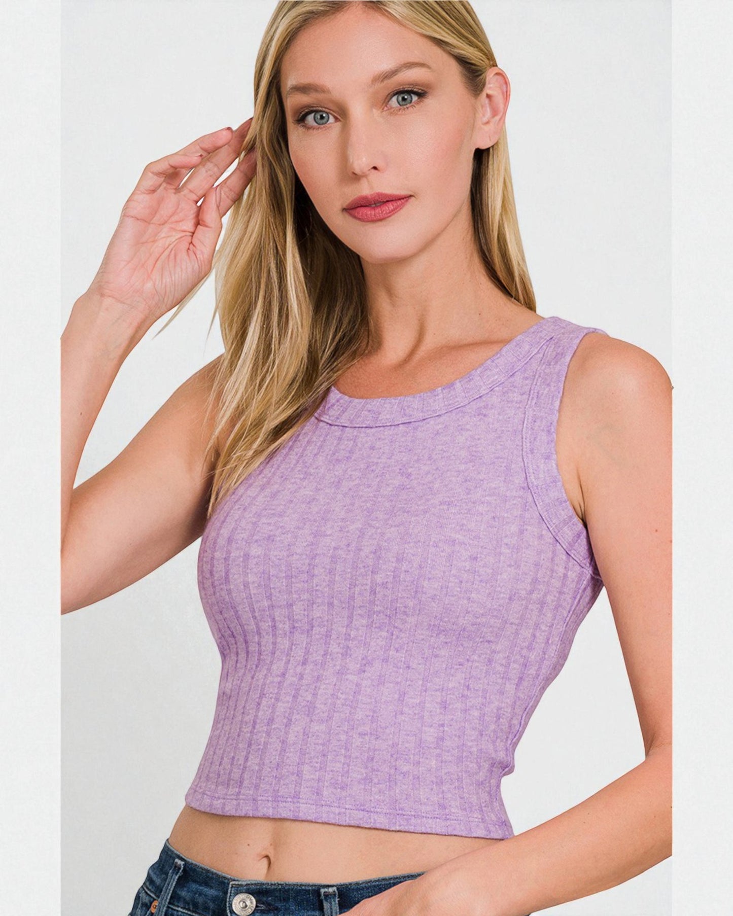 Woman wearing a purple textured tank top against a white background