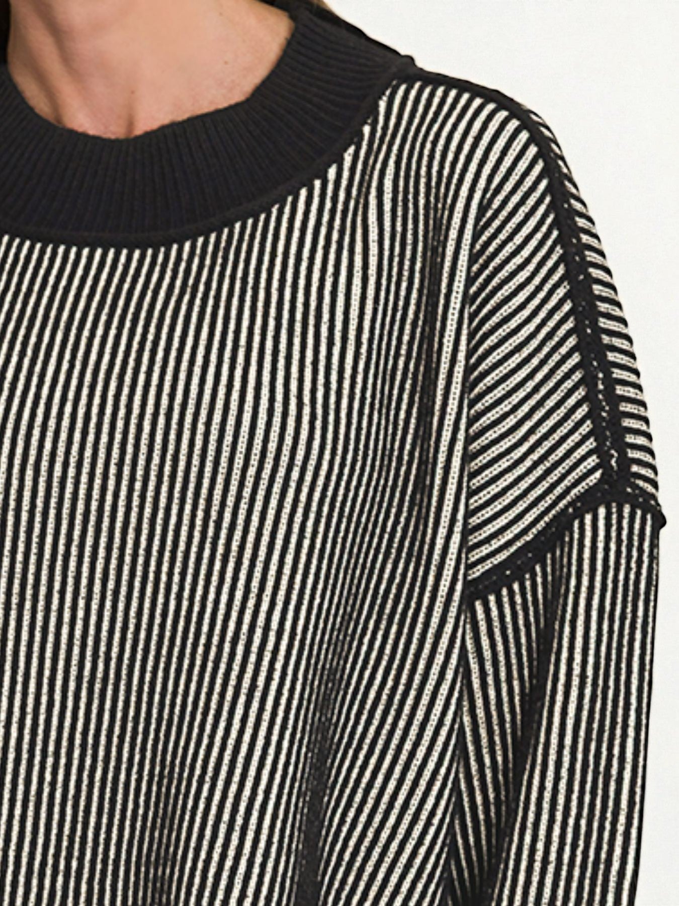 Black and white striped sweater with a close-up on the shoulder area.