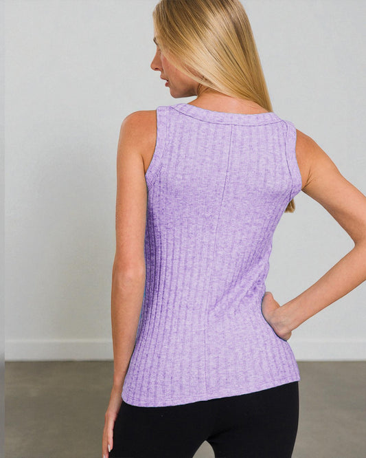 Woman wearing a purple textured tank top against a plain background