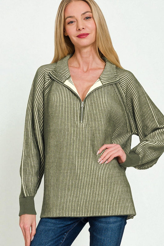 Woman wearing a green and white striped shirt with a plain background