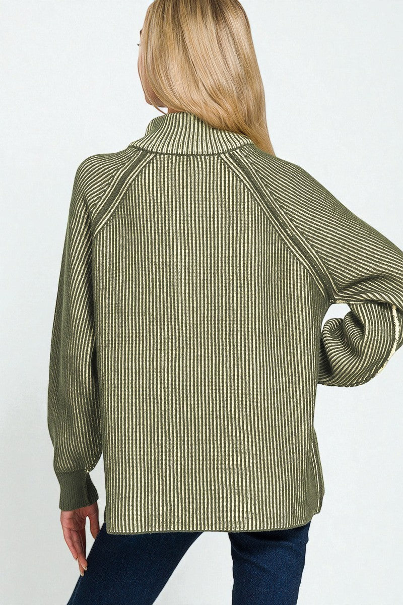 Person wearing a green ribbed sweater on a white background