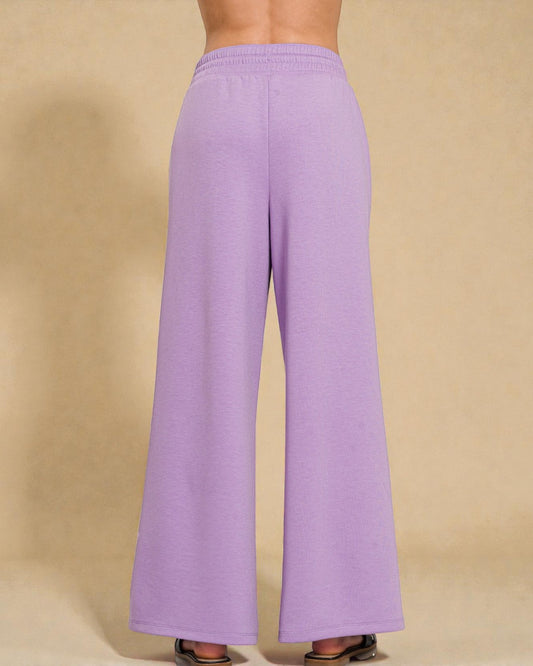 Purple wide-leg pants on a beige background