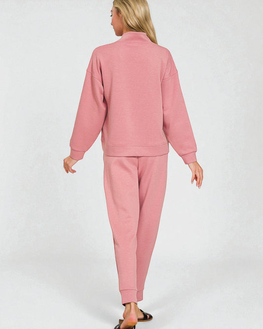 Person wearing a pink tracksuit on a white background