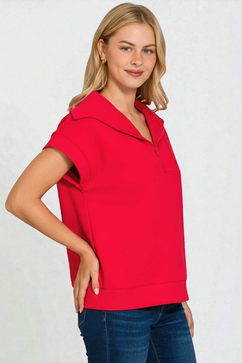 Woman wearing a red top with a white background