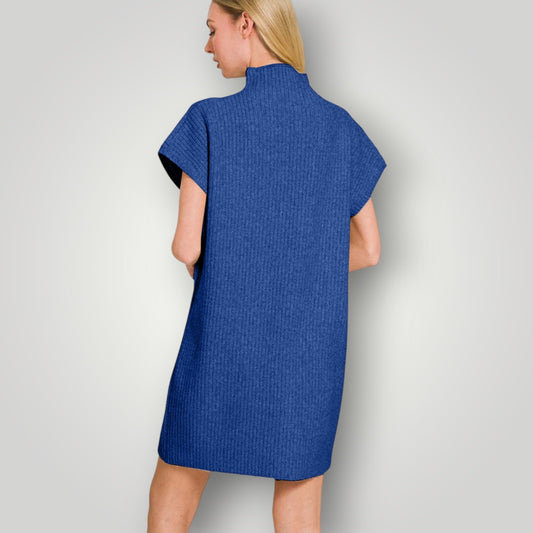 Woman wearing a blue dress against a plain background