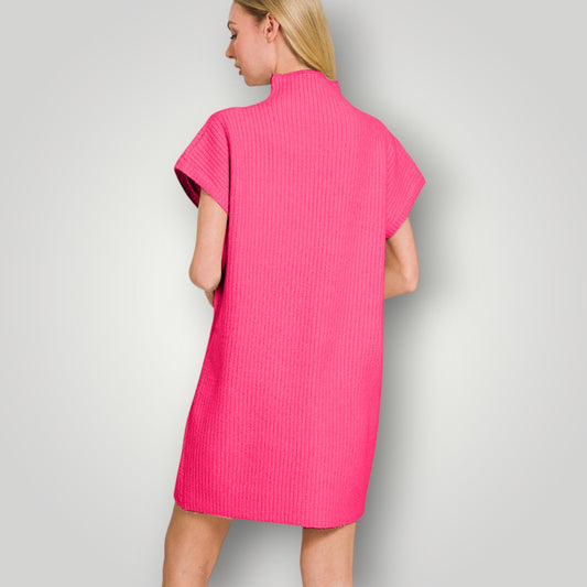 Woman wearing a bright pink dress against a plain background