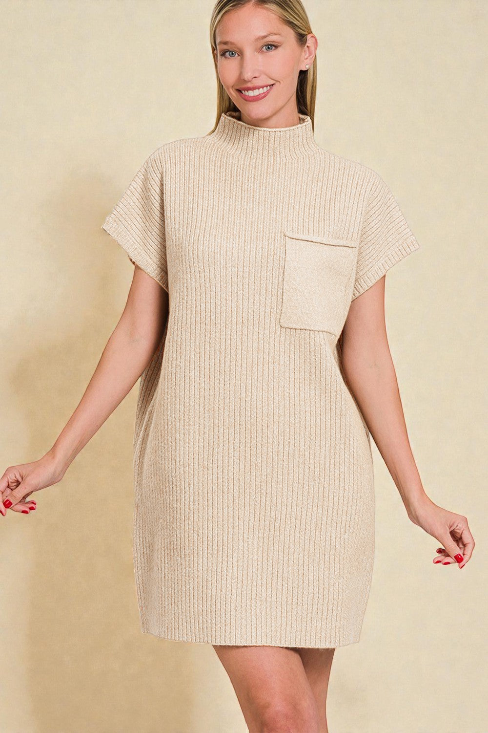 Woman wearing a beige ribbed dress with a pocket on a beige background