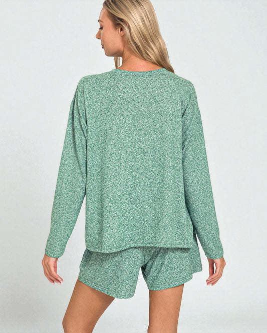 Woman wearing a green pajama set on a white background