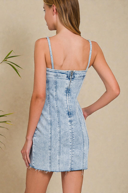 Light blue denim dress worn by a model against a beige background