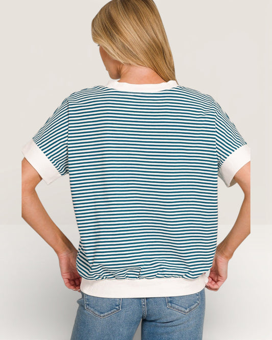 Person wearing a blue and white striped t-shirt on a plain background
