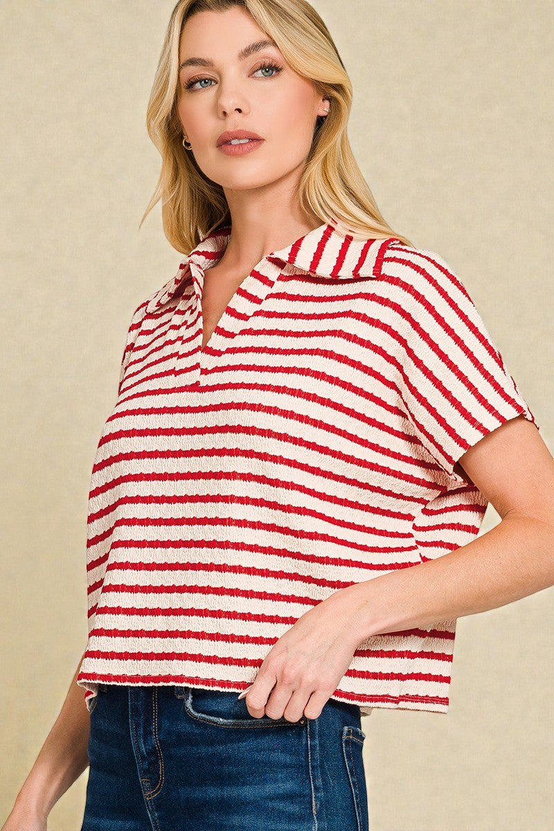 Woman wearing a red and white striped shirt against a beige background