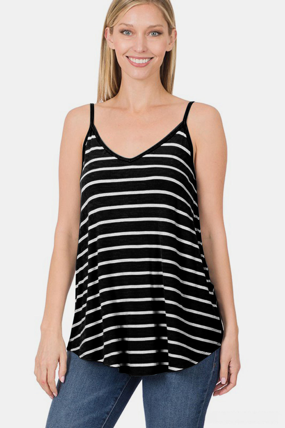 Woman wearing a black and white striped tank top against a plain background