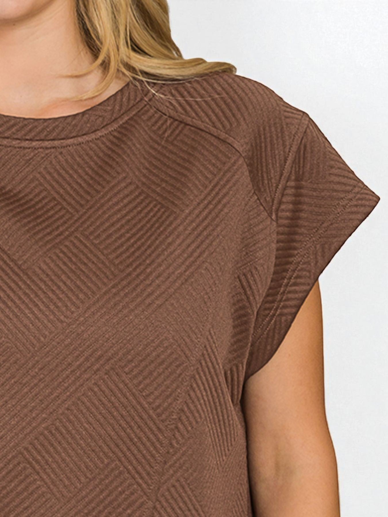 Brown textured dress with cap sleeves on a white background