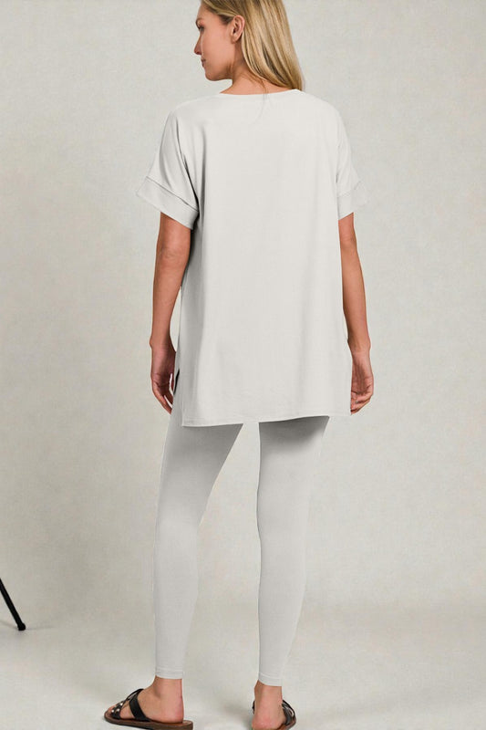 Woman wearing a white outfit on a plain background