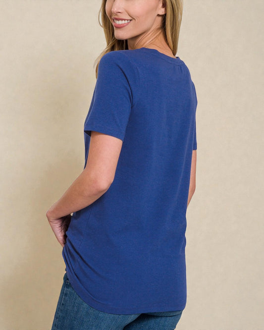 Woman wearing a blue t-shirt against a beige background