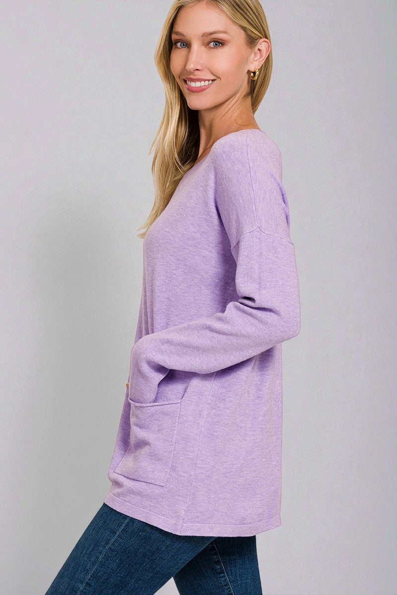 Woman wearing a light purple sweater against a gray background
