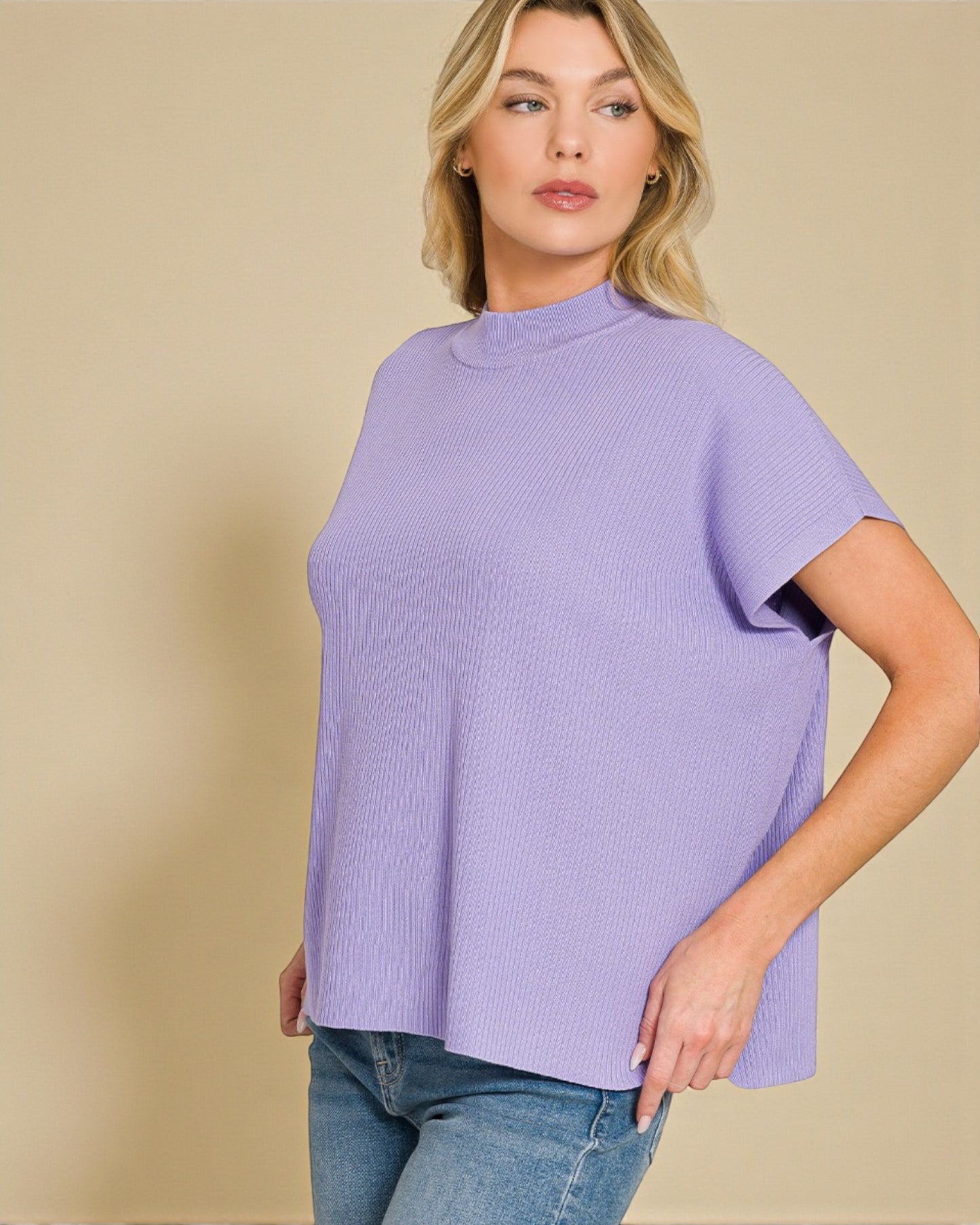 Woman wearing a light purple sweater against a beige background