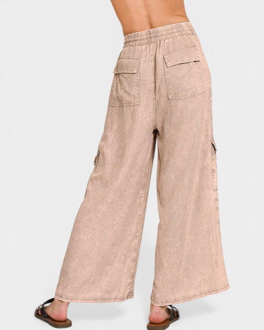 Beige wide-leg pants worn by a person on a white background