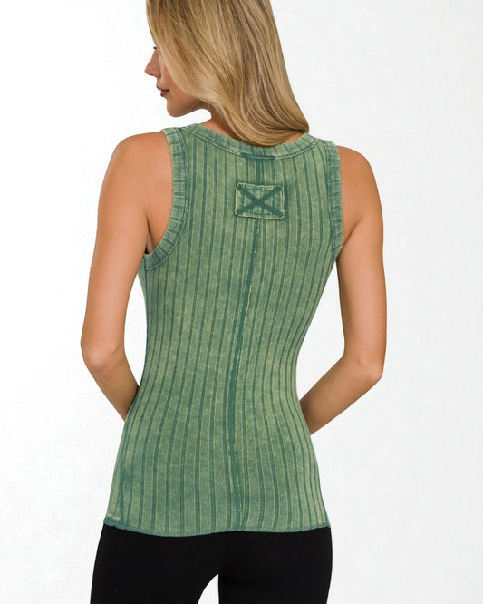 Woman wearing a green sleeveless top with a logo on a white background