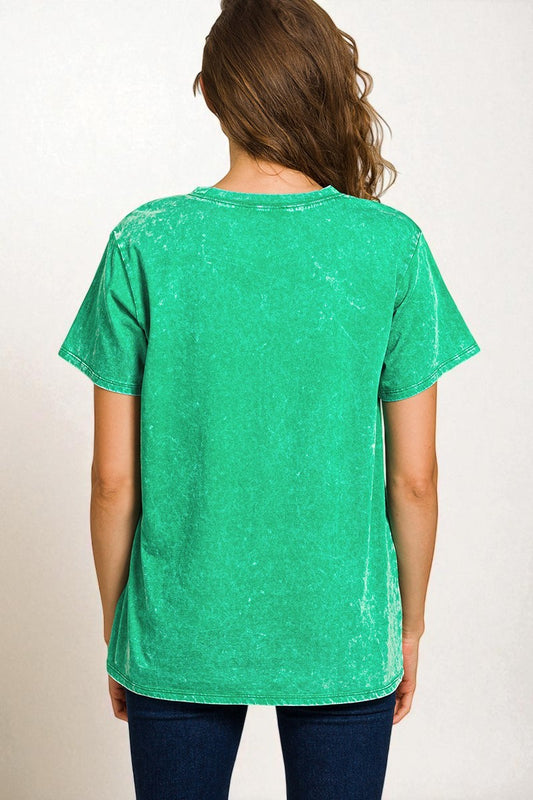 Green t-shirt worn by a person on a white background