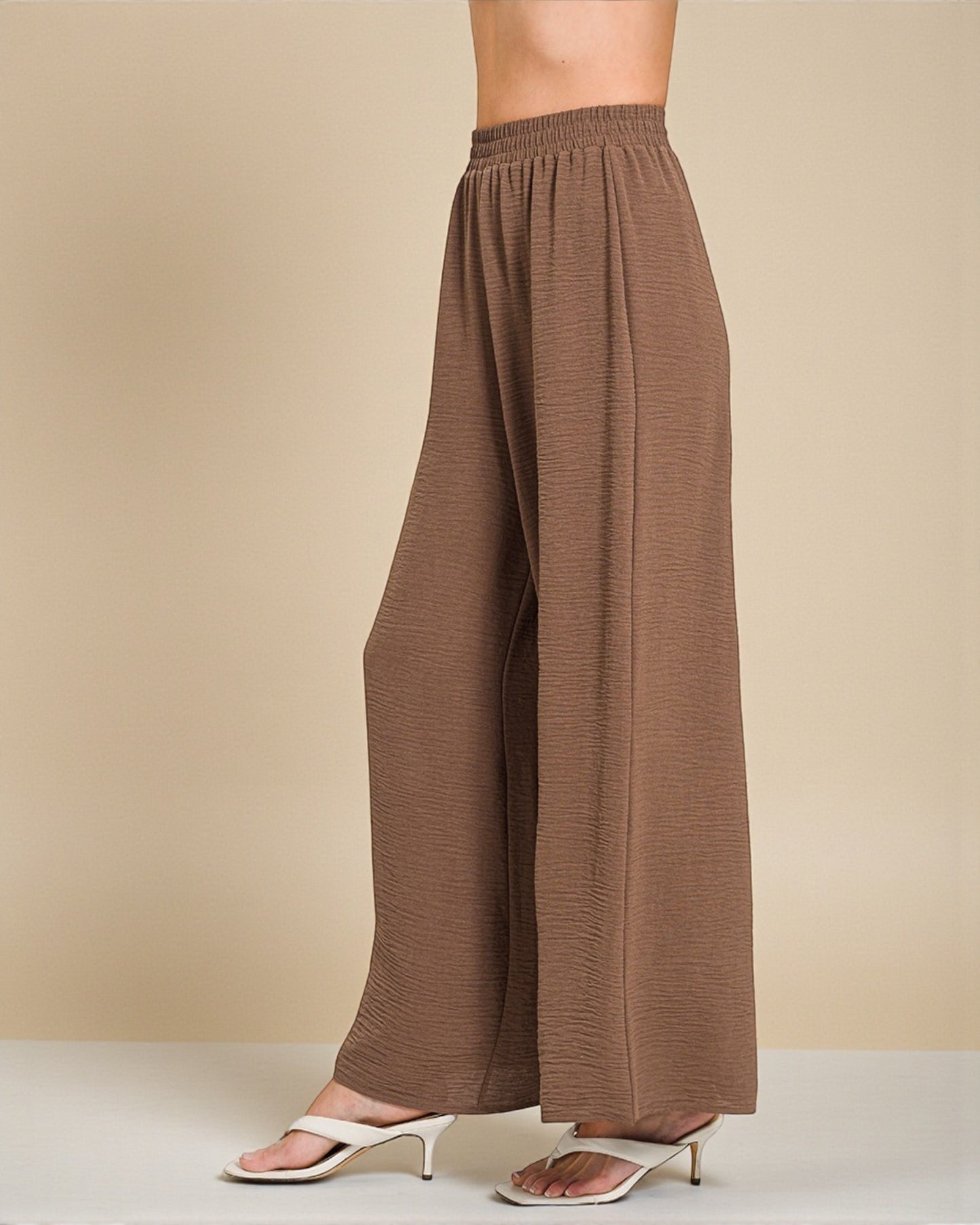 Brown wide-leg pants on a beige background