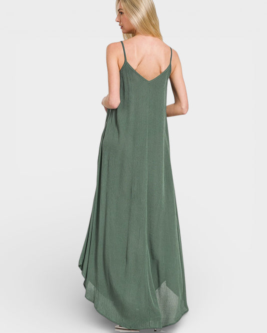 Green slip dress worn by a model on a white background