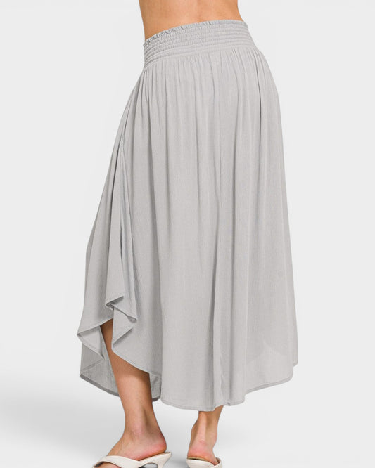 Gray skirt worn by a person on a white background