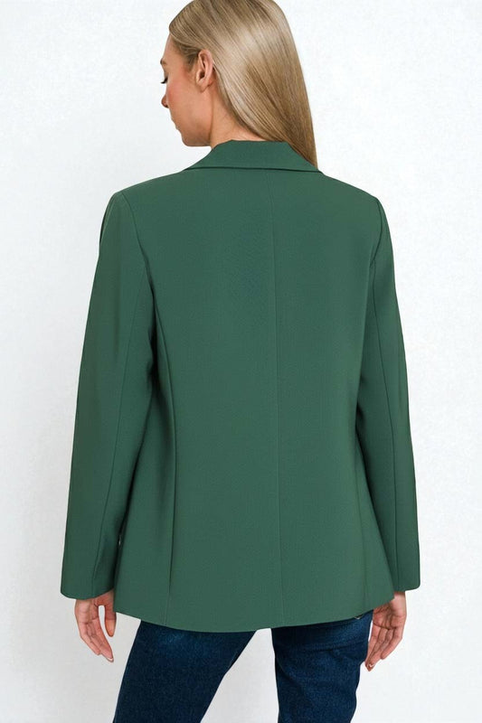 Green blazer worn by a person on a white background